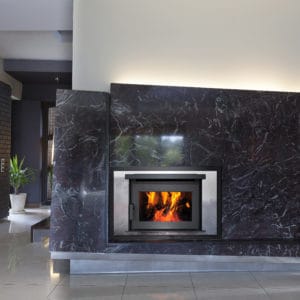 Pacific Energy FP25 wood fireplace with marble surround