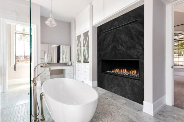 Marquis serene 47" linear gas fireplace in bathroom with marble wall